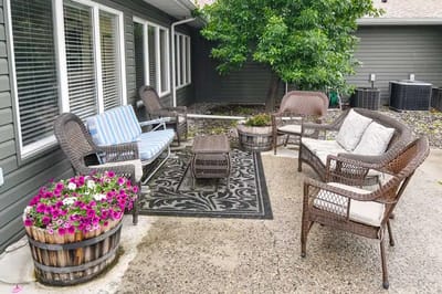 Outdoor seating area with flowers at a senior living facility