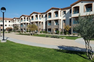 Exterior view of the facility with garden and balconies