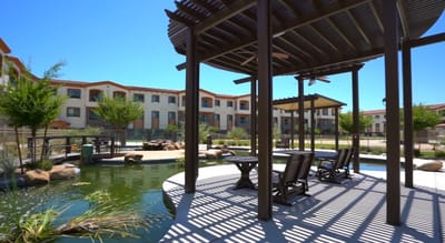 Outdoor gazebo by a pond with a view of the facility