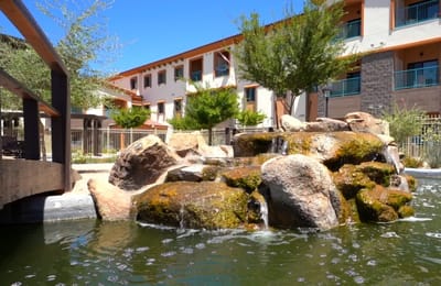 Outdoor space with a rock formation and water feature