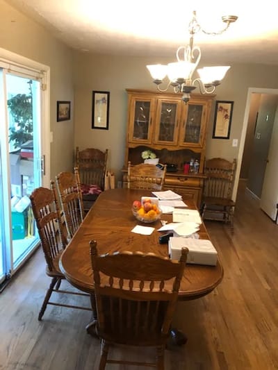 Dining area with large wooden table and chairs
