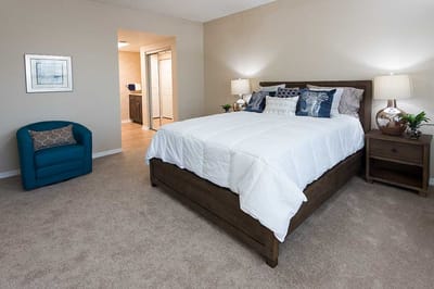 Private resident room with a bed and seating area