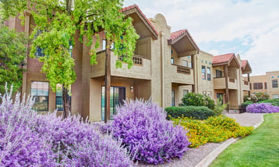 Exterior view of the Garden Ridge Senior Living building with flowers