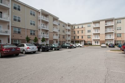 Exterior view of Golden Manor Senior Apartments with parking area