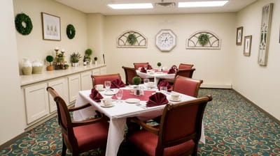 Dining room set up for a meal with decorative table settings