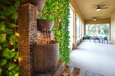 Decorative water fountain with greenery in common area