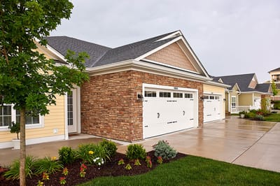 Exterior view of a senior living facility with landscaped entrance