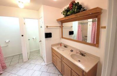 Clean bathroom with double sinks and a large mirror