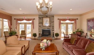 Cozy lobby with seating and fireplace in an assisted living facility