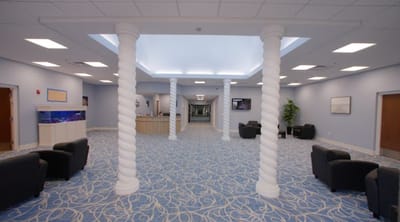 Brightly lit lobby area with seating and decorative columns