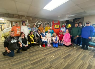 Staff members celebrating with costumes in a common area