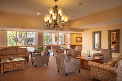 Cozy common area with comfortable seating and a chandelier