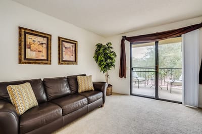 Cozy lounge area with a couch and balcony view