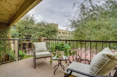 Balcony view with chairs and greenery