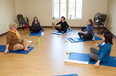 Residents participating in a yoga class in an indoor space