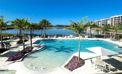 Pool area with palm trees and lake view