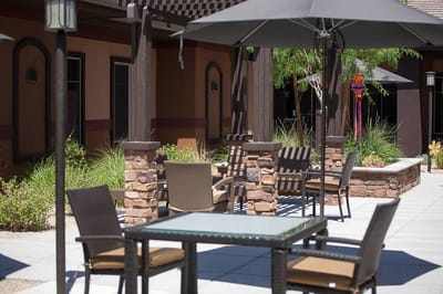 Outdoor seating area with tables and umbrellas