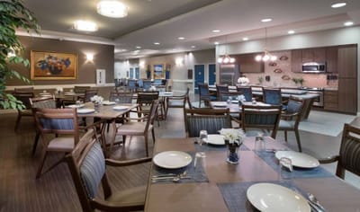 Dining area with tables and chairs set for meals