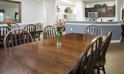 Dining area with wooden tables and flowers