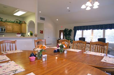 Dining area with a wooden table and flower arrangements