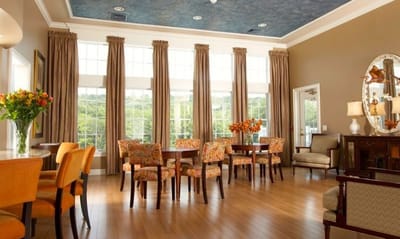 Bright and welcoming common area with seating and floral arrangements