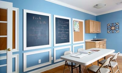 Bright activity room with tables and chalkboards