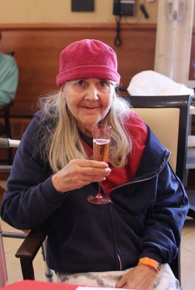 Resident celebrating with a glass of champagne
