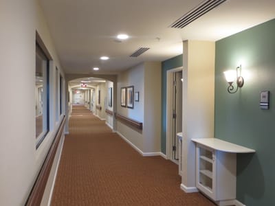 Wide view of a facility hallway with carpet