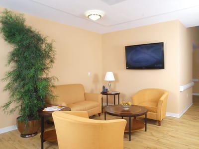 Bright common area with seating and a TV