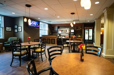 Common area with tables and chairs in a cozy lounge