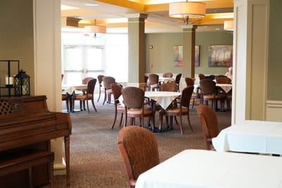 Dining room with tables and chairs set up for meals