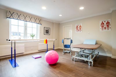 Physical therapy room with equipment and ball
