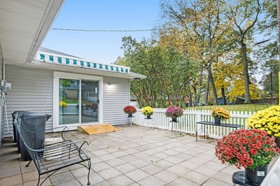Outdoor patio area with flower pots and seating