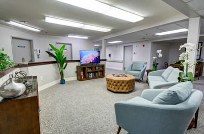 Bright common area with seating and television