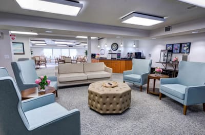 Bright common area with seating and decor.