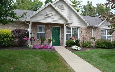 Exterior view of a senior living facility with gardens