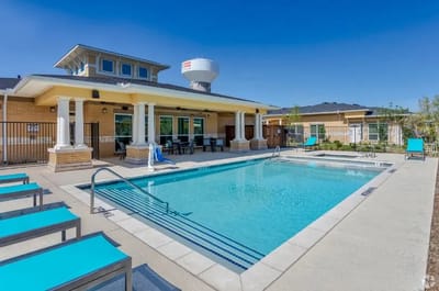 Outdoor pool area with lounge chairs