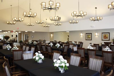 Bright dining room with floral centerpieces and large chandeliers