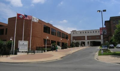 Exterior view of St. Bernards Medical Center with flags