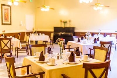 Elegant dining setup with tables and flowers