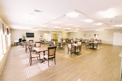 A spacious common area with tables and chairs