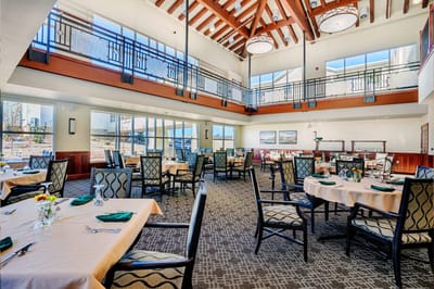Bright dining area with tables and chairs set for meals
