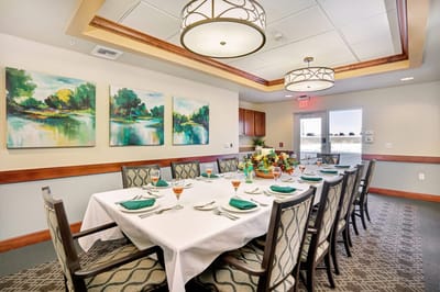 Dining room with elegantly set table and artwork on the wall