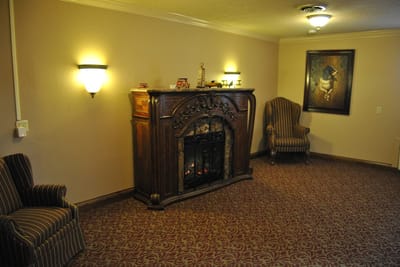 Cozy common area with seating and decorative fireplace