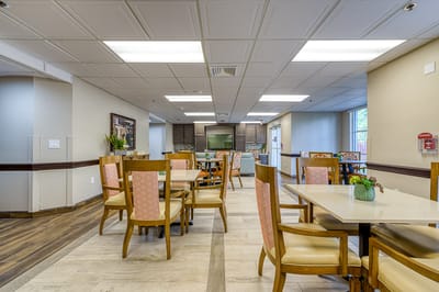 Common area with tables and chairs in a dining setting