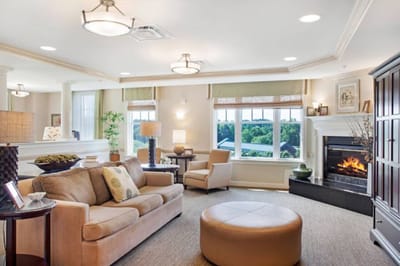 Bright common area with seating and a fireplace