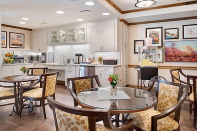 Bright dining area with tables and artwork on the walls