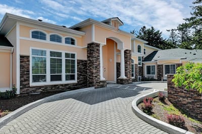 Exterior view of Tabor Crest Memory Care building with landscaping