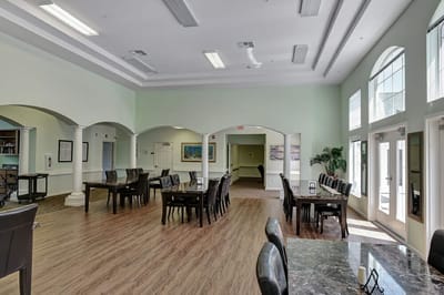 Bright and spacious common area with tables and chairs