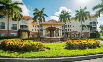 Exterior view of the facility with fountain and gardens